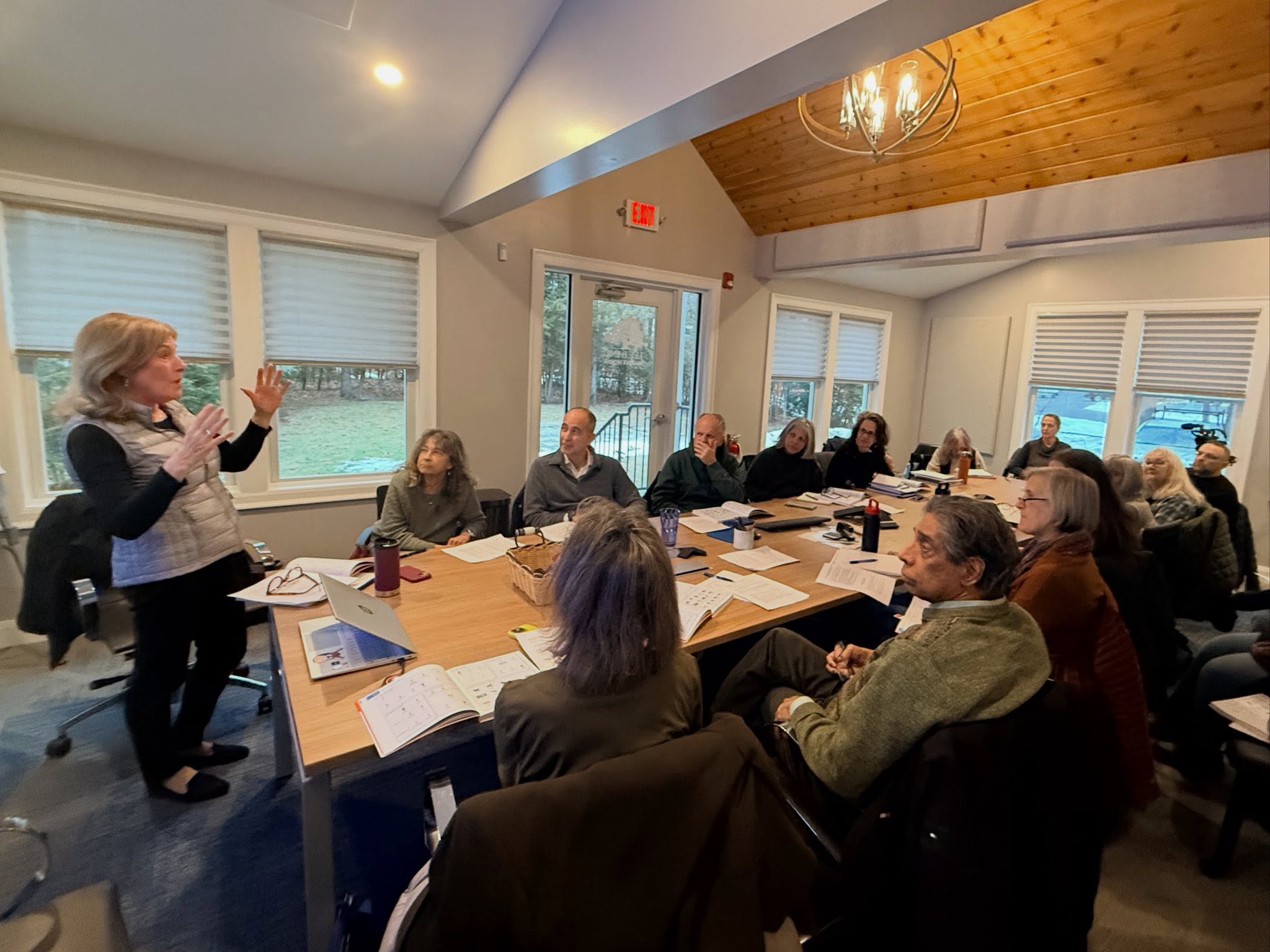 LitNet tutors at a training workshop around a conference table